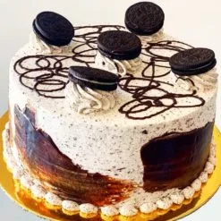 Oreo Cake - Moist chocolate sponge filled and frosted with Oreo-flavored cream, decorated with Oreo cookie crumbs and whole cookies, perfect for celebrations