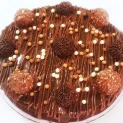 Brownie Rocher Cake - Moist chocolate brownie filled and frosted with Ferrero Rocher-flavored frosting, adorned with whole Ferrero Rocher chocolates and chocolate drizzle, perfect for celebrations