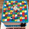 Snake & Ladder Theme Cake with colorful board design and edible game pieces